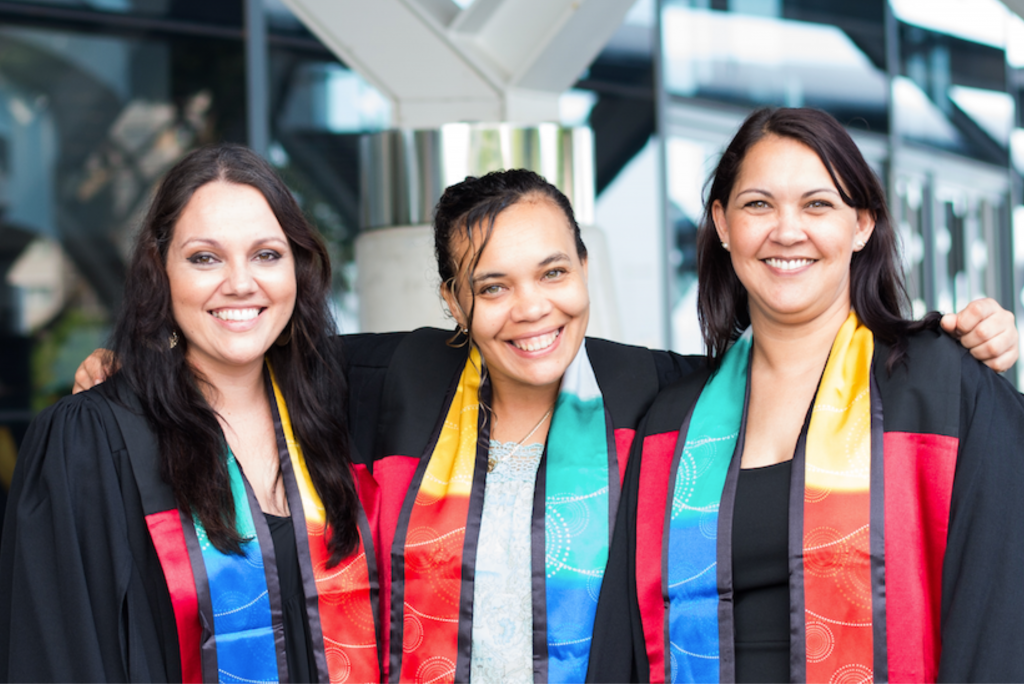 Three Indigenous CDU Student smile at Graduation Ceremony at Convention Centre